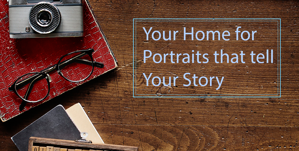 View From Home Photography - Your home for portraits that tell your story Portrait Photography.  Wood desktop with camera, glasses, and red notebook.